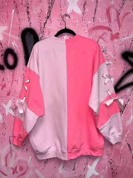 Pink and hot pink crew neck on textured background 