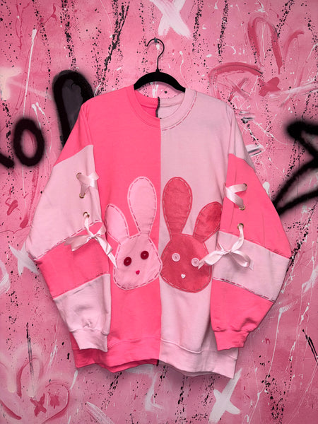 Pink crew neck with bunny design on a pink background